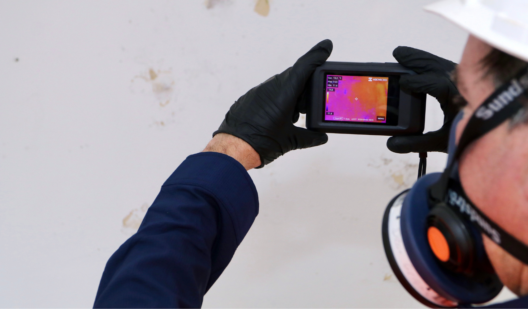 “Mould inspections Central Coast home — professional environmental consultant testing wall surface for hidden moisture.