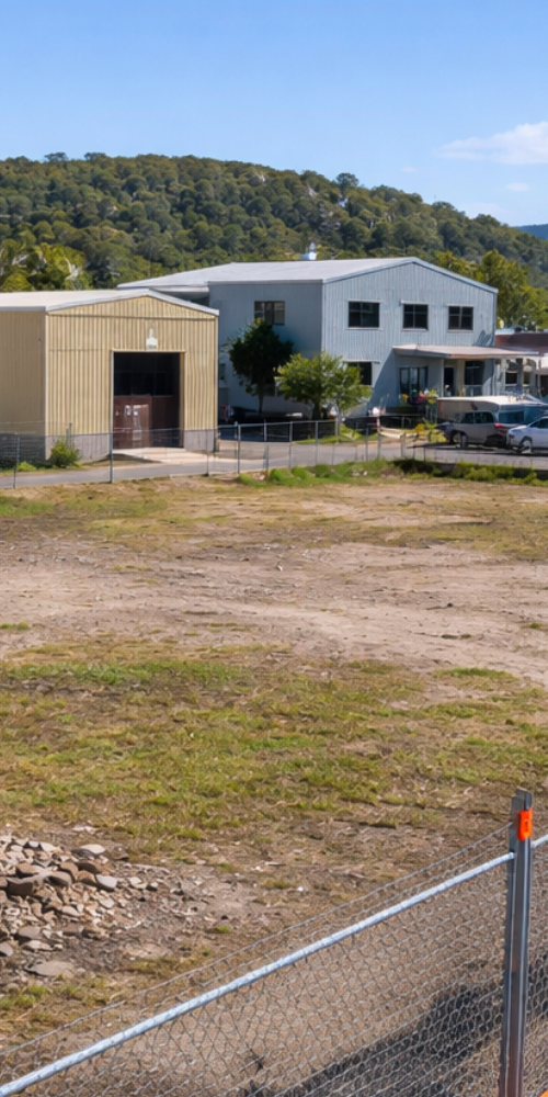 Vacant development site on the Central Coast showing surrounding land uses, a common trigger for contaminated land assessment during DA review.